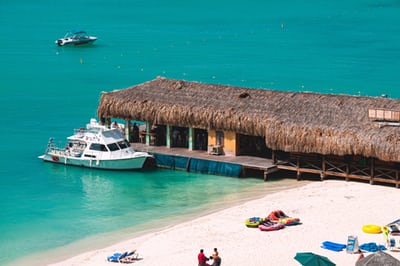 small vessel docked beside covered dock in oranjestad aruba