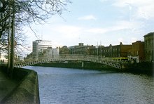 view of the city from a river and bridge in dublin ireland